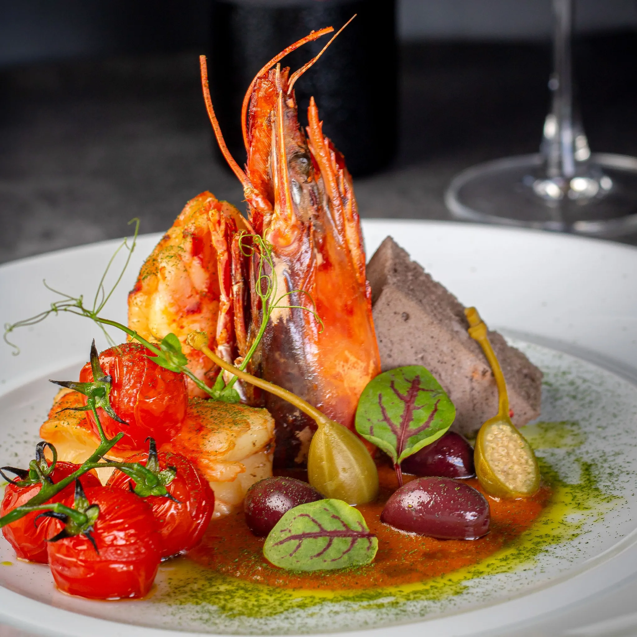 Beautifully plated red prawn with dramatic presentation