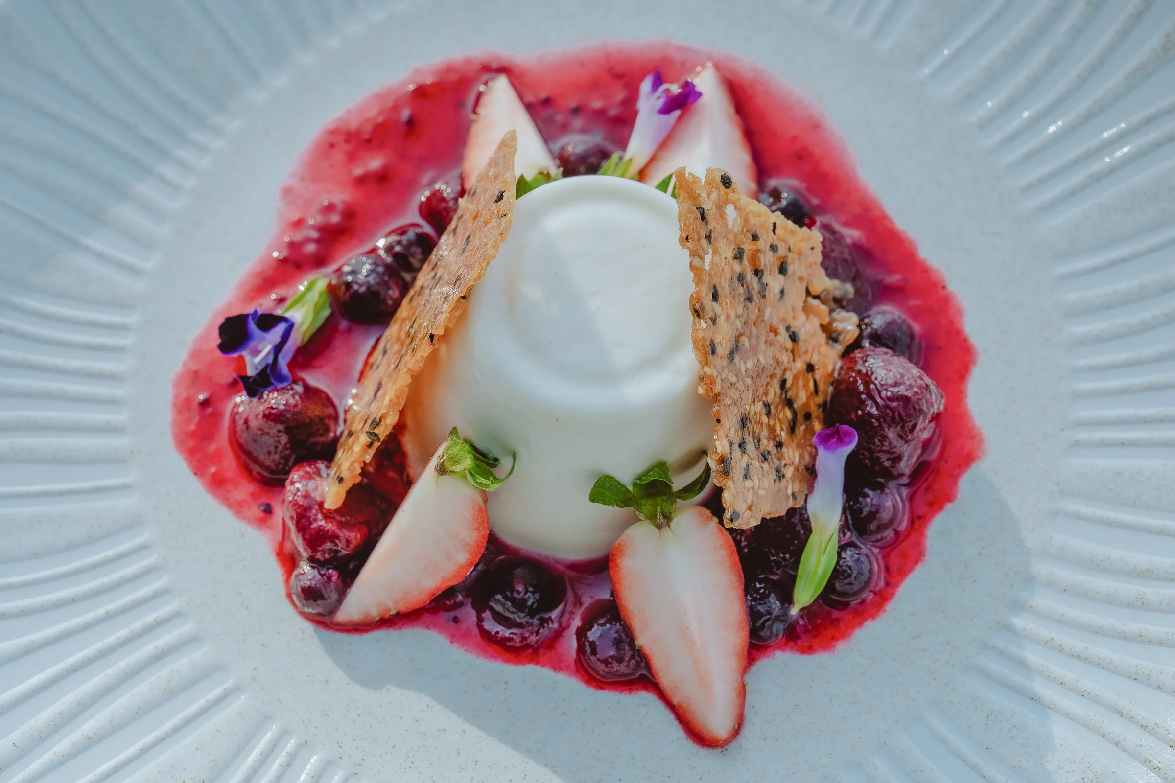 Classic Italian panna cotta topped with fresh mixed berries
