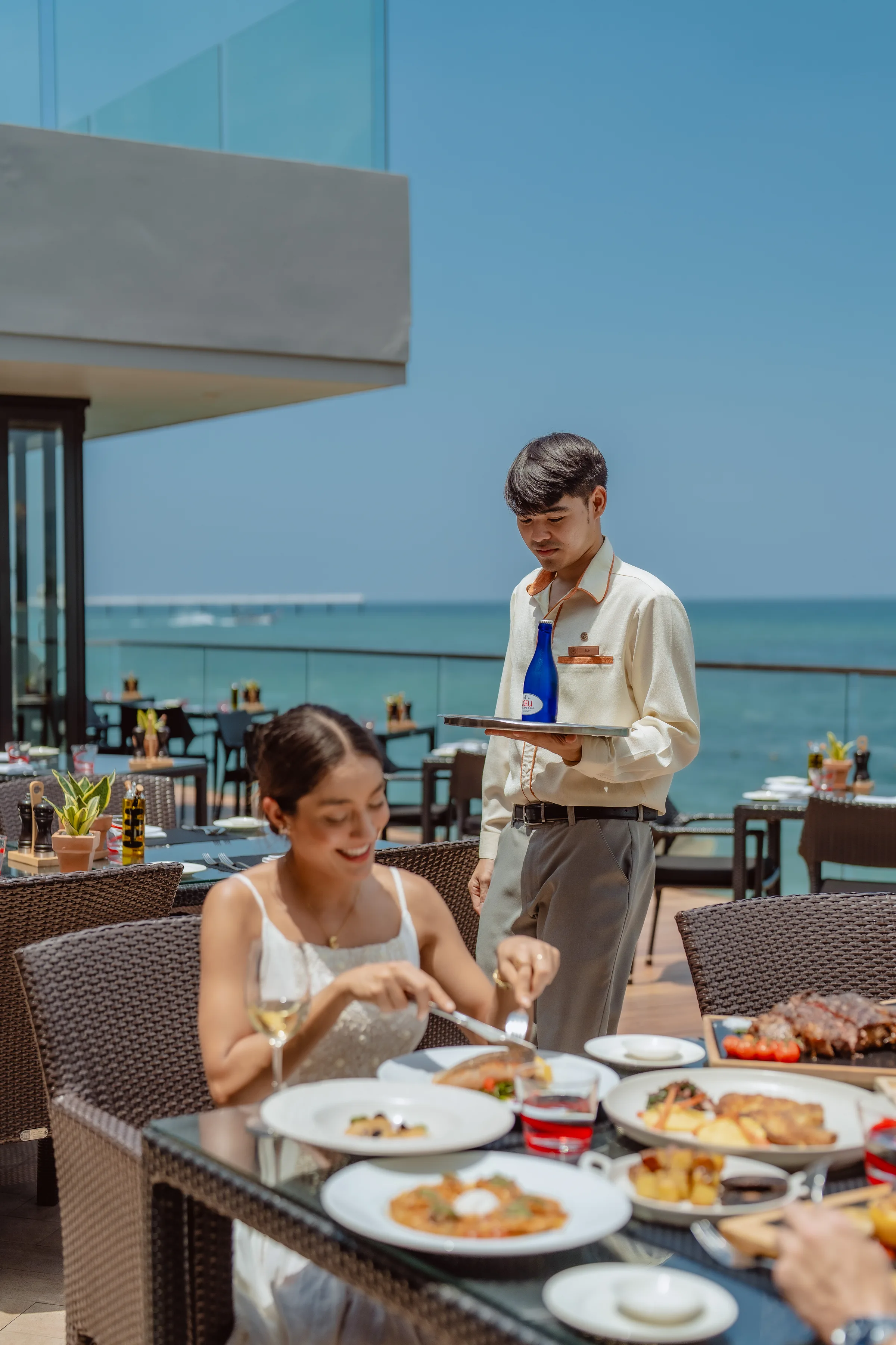 Attentive waiter serving a guest at the terrace
