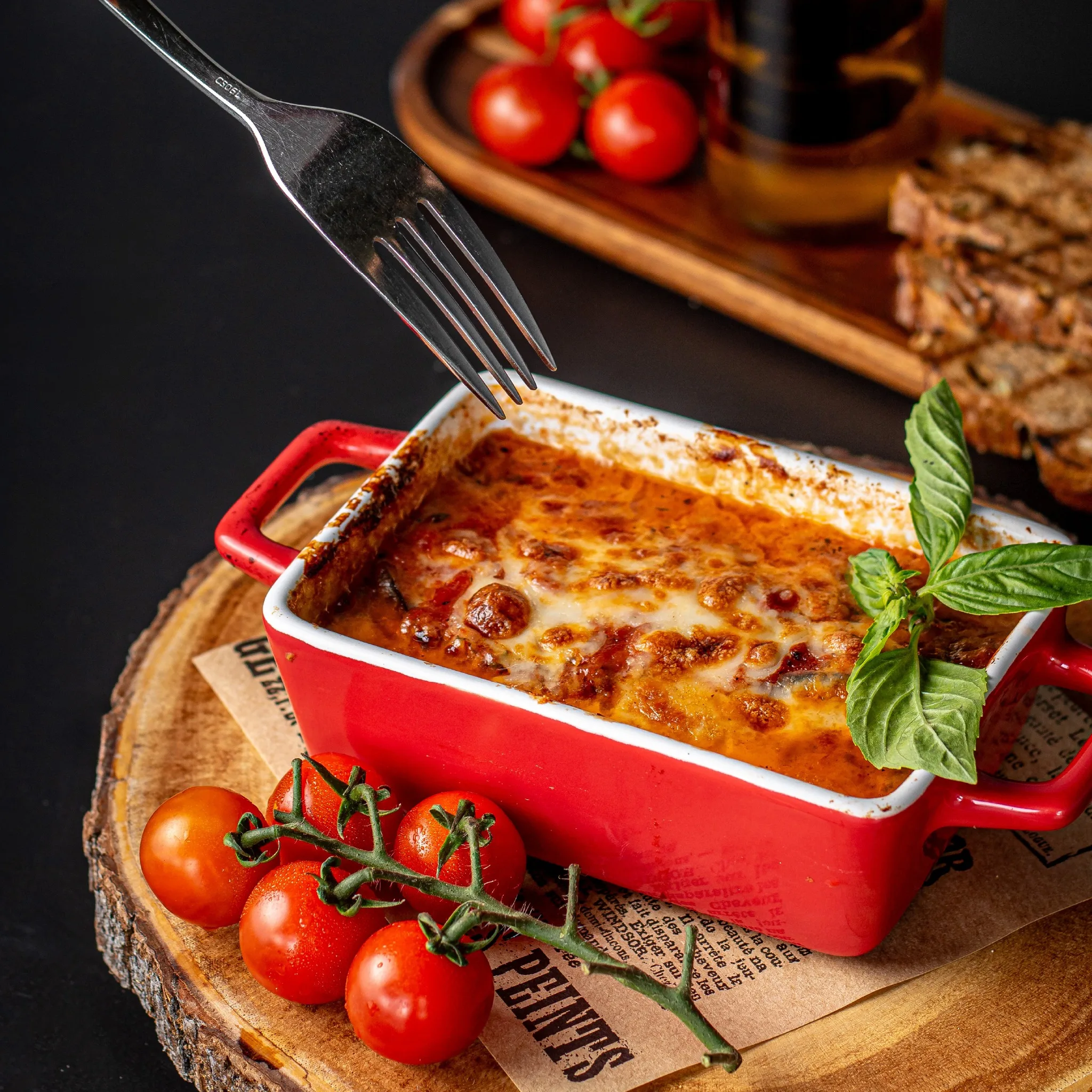 Traditional Italian lasagna served in a red cocotte